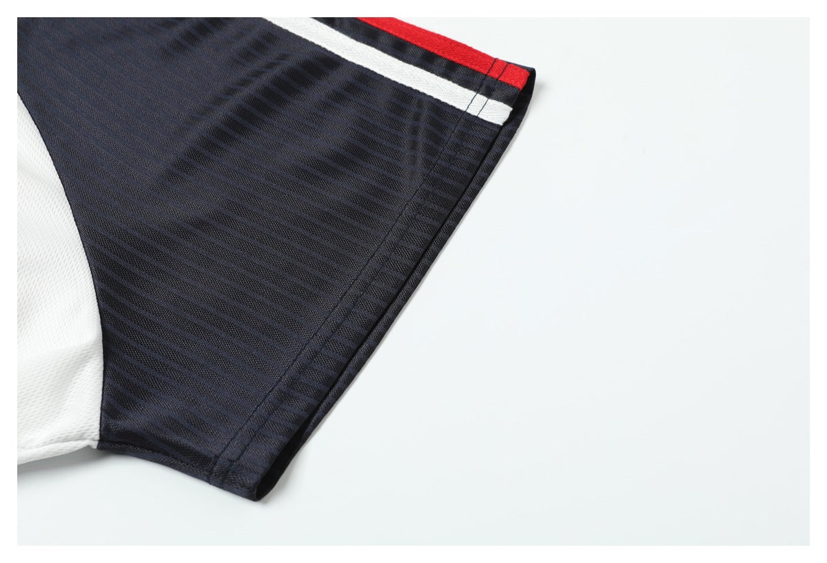 Close-up of a dark pinstriped jersey sleeve with white paneling and red-and-white trim.