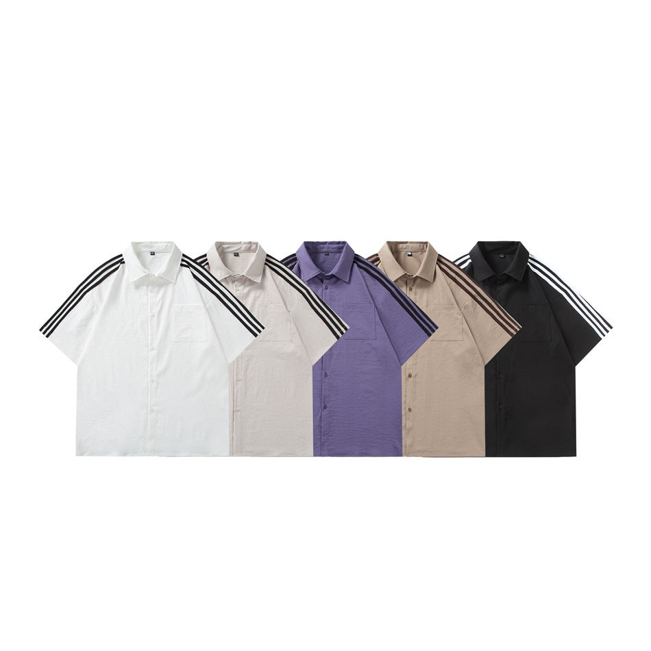 Five short-sleeve collared shirts in white, off-white, purple, tan, and black, each with striped shoulders.