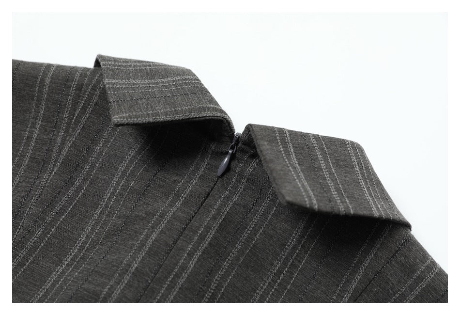 Close-up of a charcoal gray striped shirt collar and neckline with a small zipper visible.