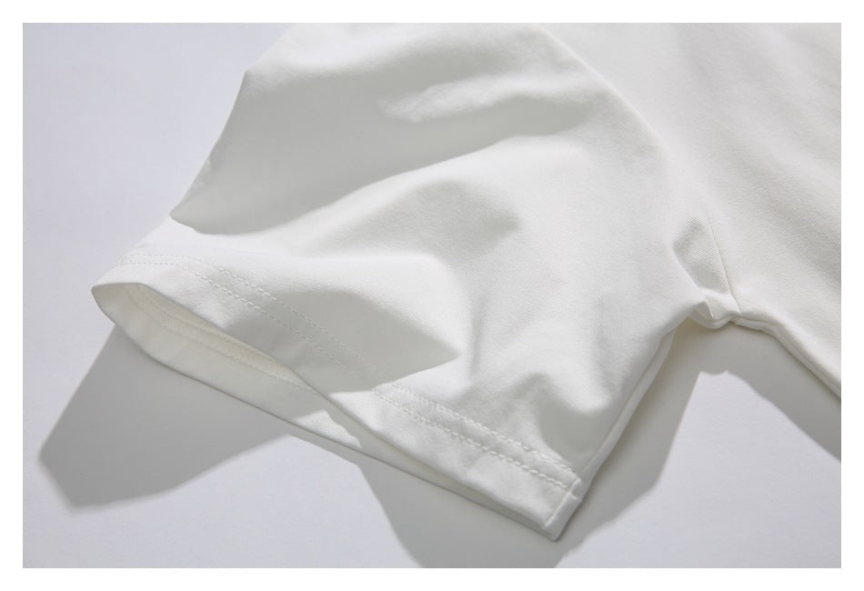 Close-up of the stitched sleeve hem on the white shirt.