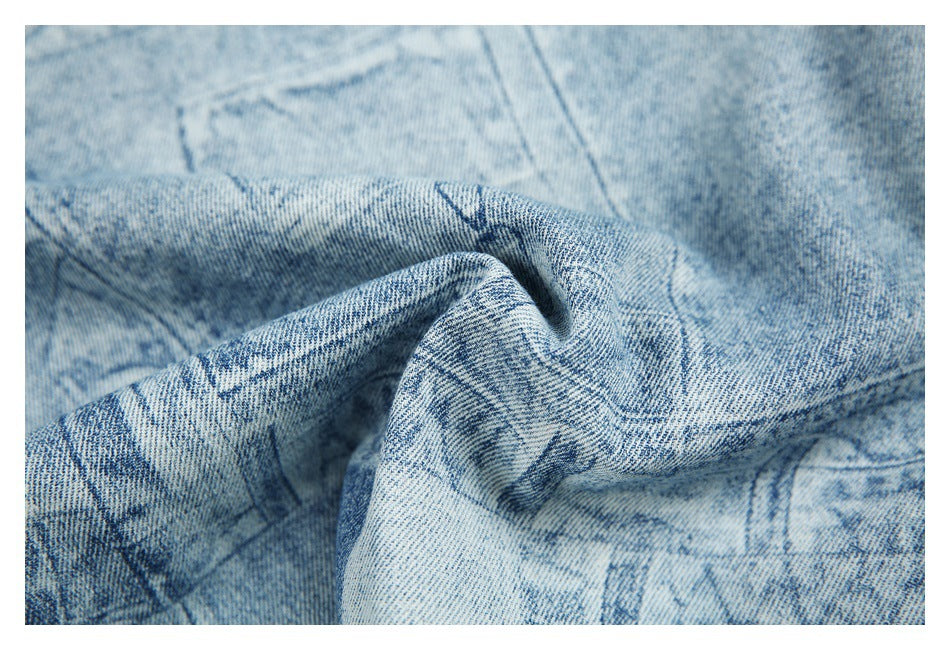 Close-up of the textured light blue denim fabric gathered to show its distressed printed pattern.