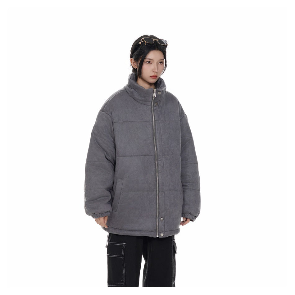 Model in a three-quarter view wearing a charcoal-gray padded jacket with a high collar and front zipper.
