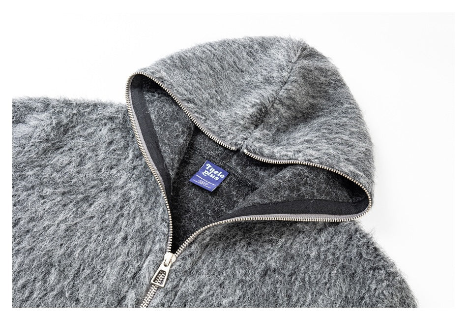 Close-up of the gray jacket's hood opening, dark lining, zipper, and sewn-in label.