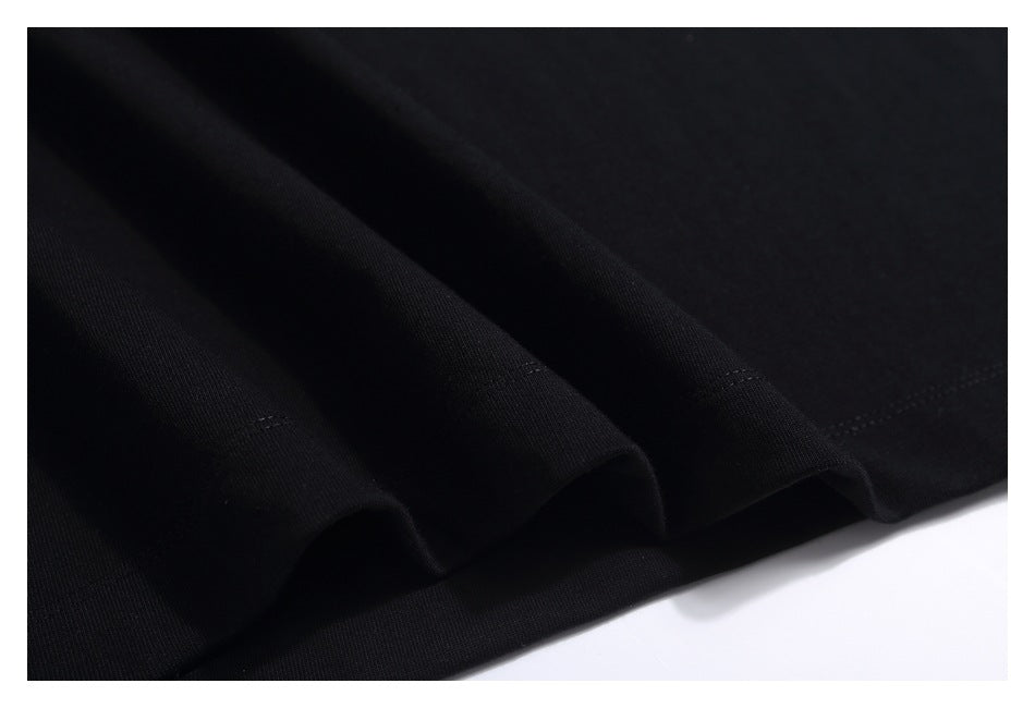 Close-up of black T-shirt fabric arranged in soft folds.