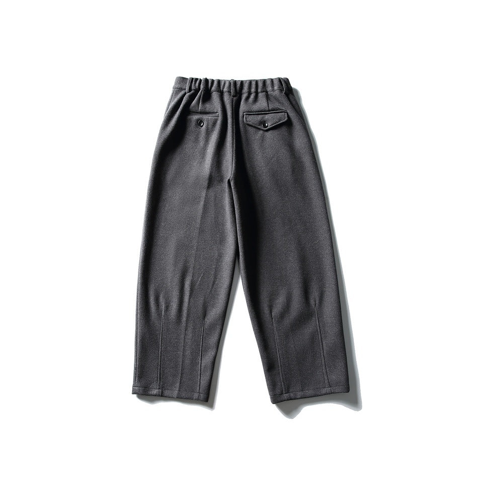 Back view of charcoal wide-leg trousers with an elasticated waist and two buttoned back pockets.