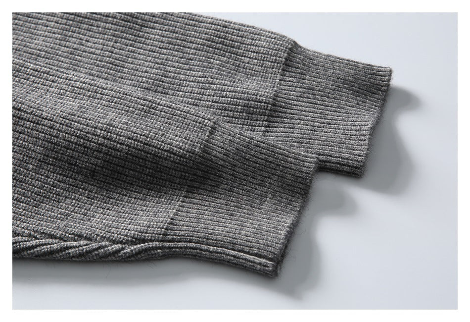 Close-up of a gray rib-knit cardigan sleeve ending in a wide ribbed cuff.