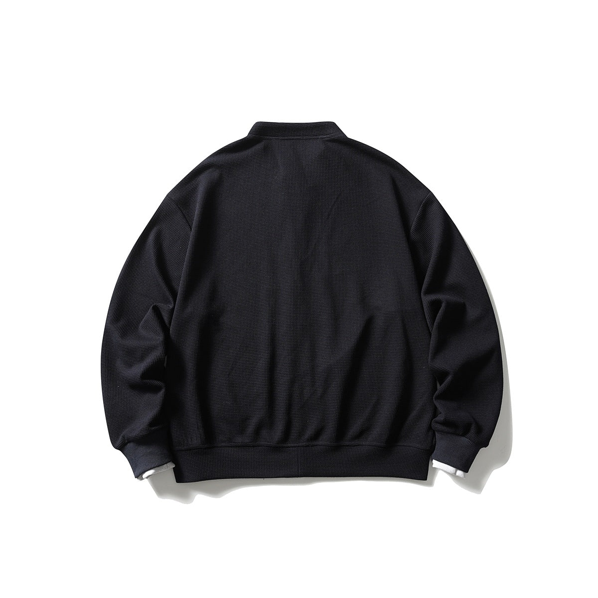 Back view of a black jacket with a stand collar, long sleeves, and ribbed cuffs and hem.