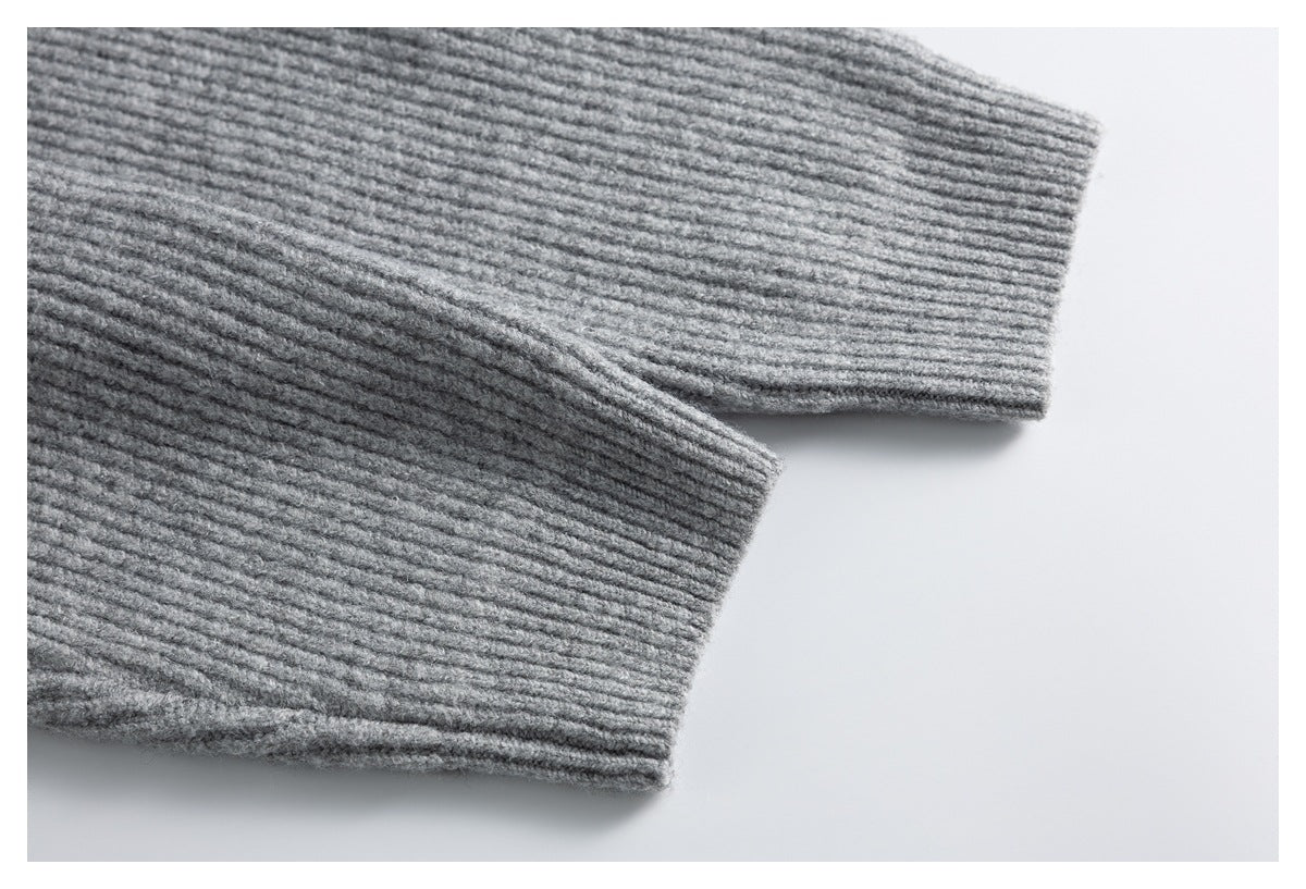 Close-up of two ribbed gray cardigan sleeve cuffs.