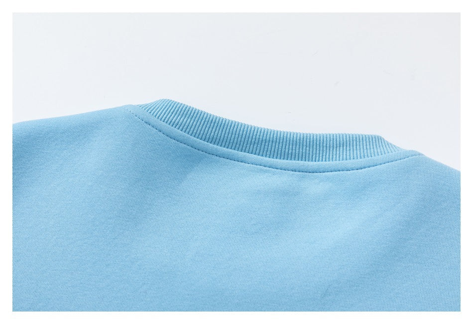 Close-up of the ribbed neckline and plain back of a light blue garment.