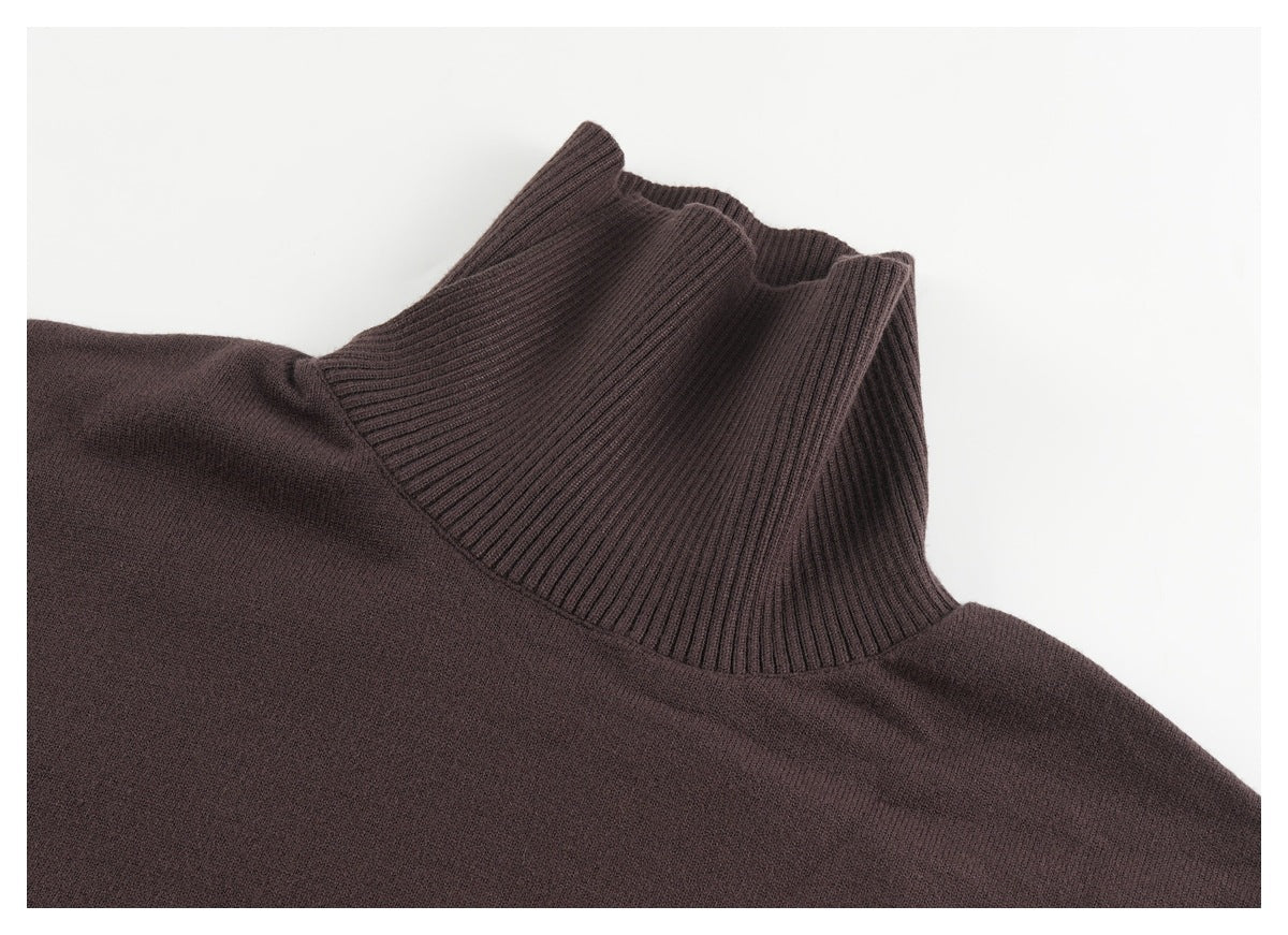 Close-up of a dark brown knit sweater showing its tall ribbed mock-neck collar.