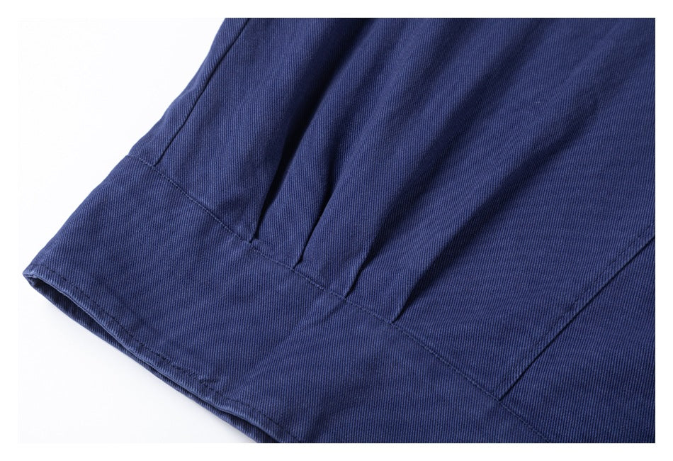 Close-up of the navy jacket's lower hem and stitched seam.
