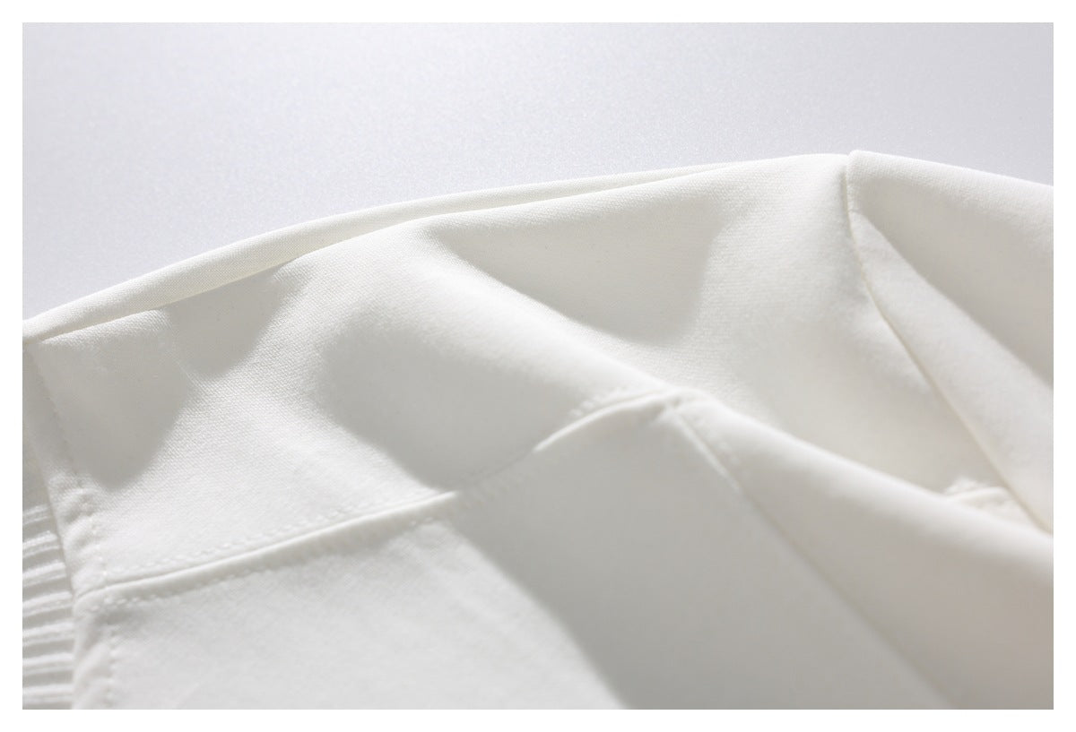 Close-up of a white garment with a stitched seam and ribbed edge.