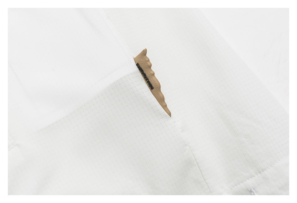 Close-up of a small tan label with black lettering on white grid-textured fabric.