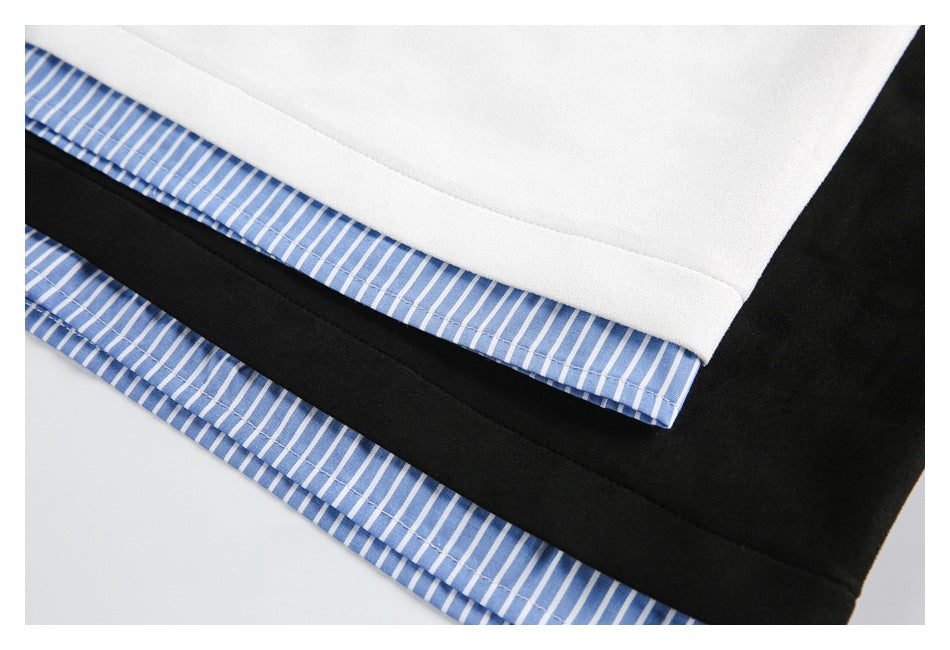 Close-up of blue striped fabric peeking below the hems of white and black tops.