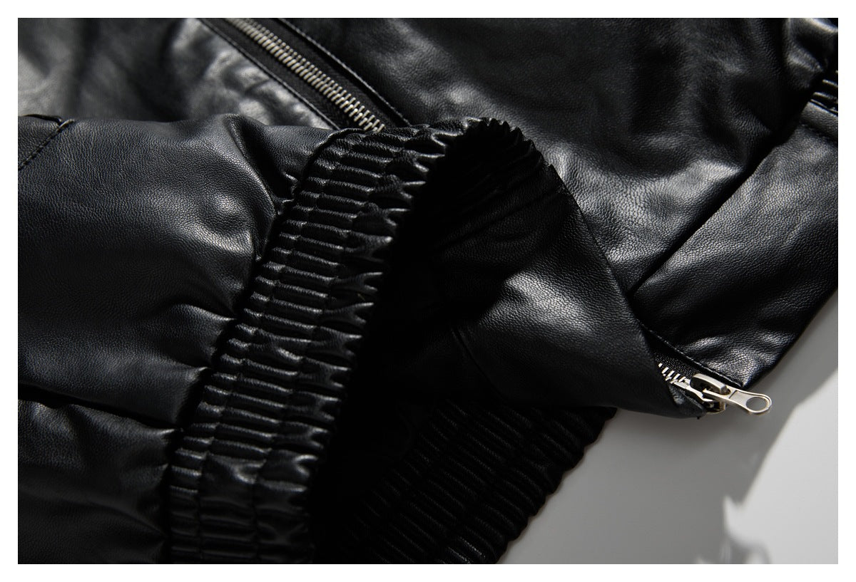 Close-up of a black jacket sleeve, ribbed cuff, and metal zipper pull.