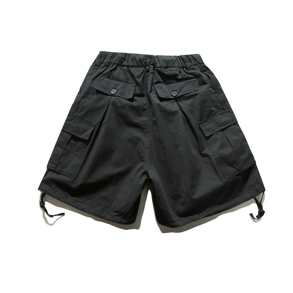Back view of black cargo shorts with buttoned back pockets, side cargo pockets, and adjustable hem straps.
