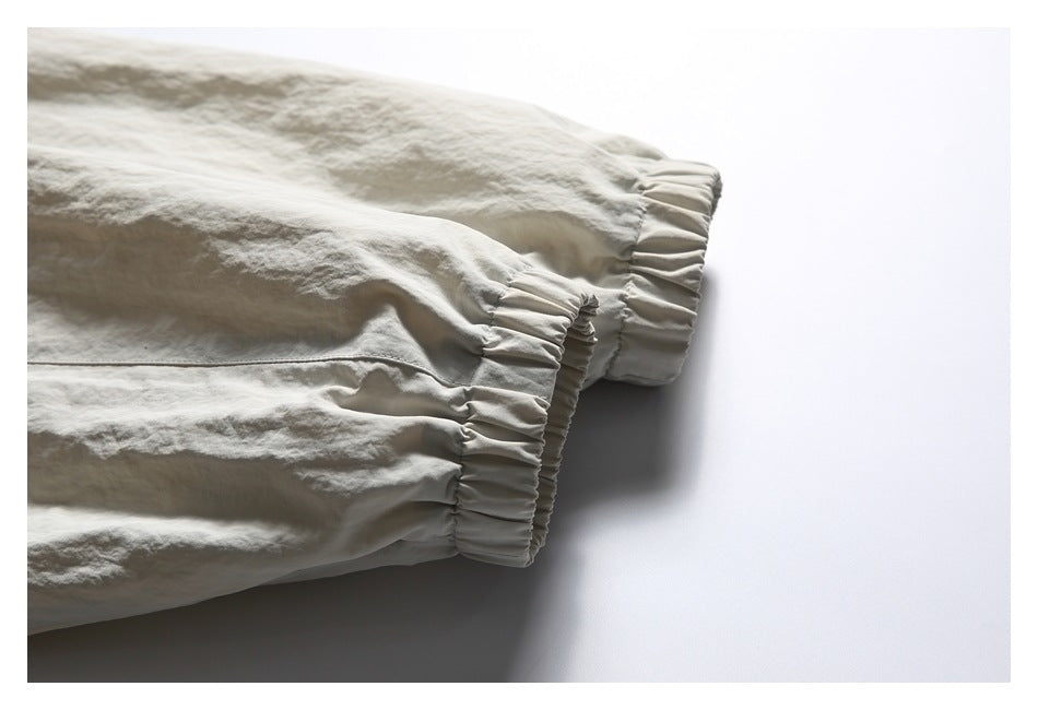 Close-up of the light beige jacket's gathered elastic sleeve cuffs.