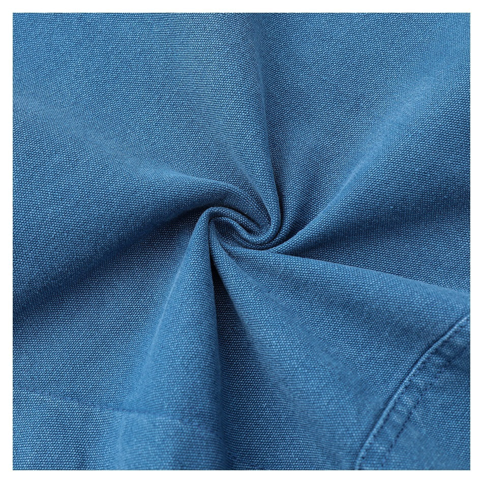 Close-up of blue woven fabric twisted into a spiral to show its texture and drape.