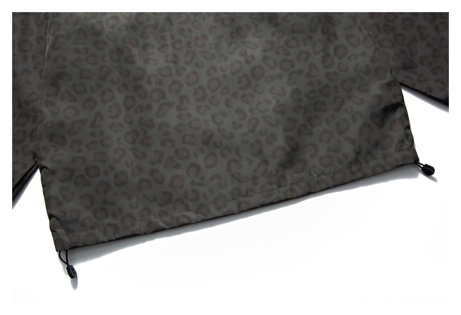 Close-up of the jacket's leopard-print lower hem with adjustable drawcords at the sides.