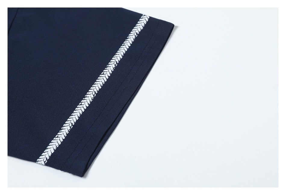 Close-up of a navy short sleeve with a narrow white chevron stripe near the hem.