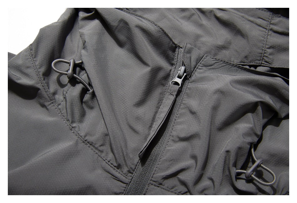 Close-up of the gray jacket's hood adjustment cord and front zipper area.