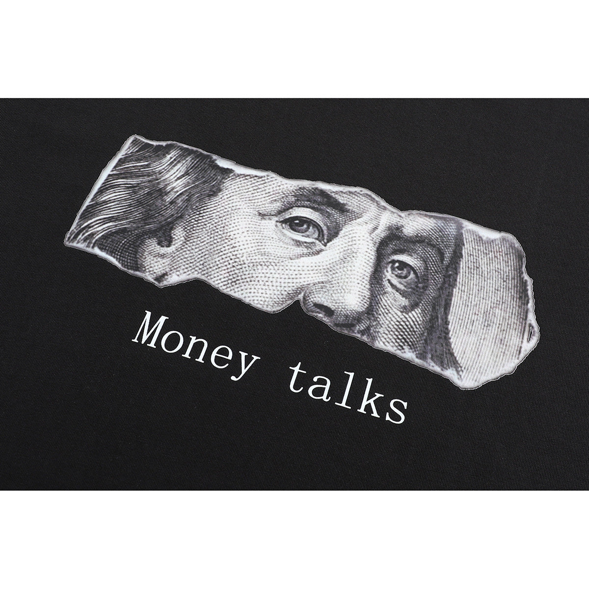 Close-up of a black T-shirt graphic with a grayscale portrait and the words “Money talks.”