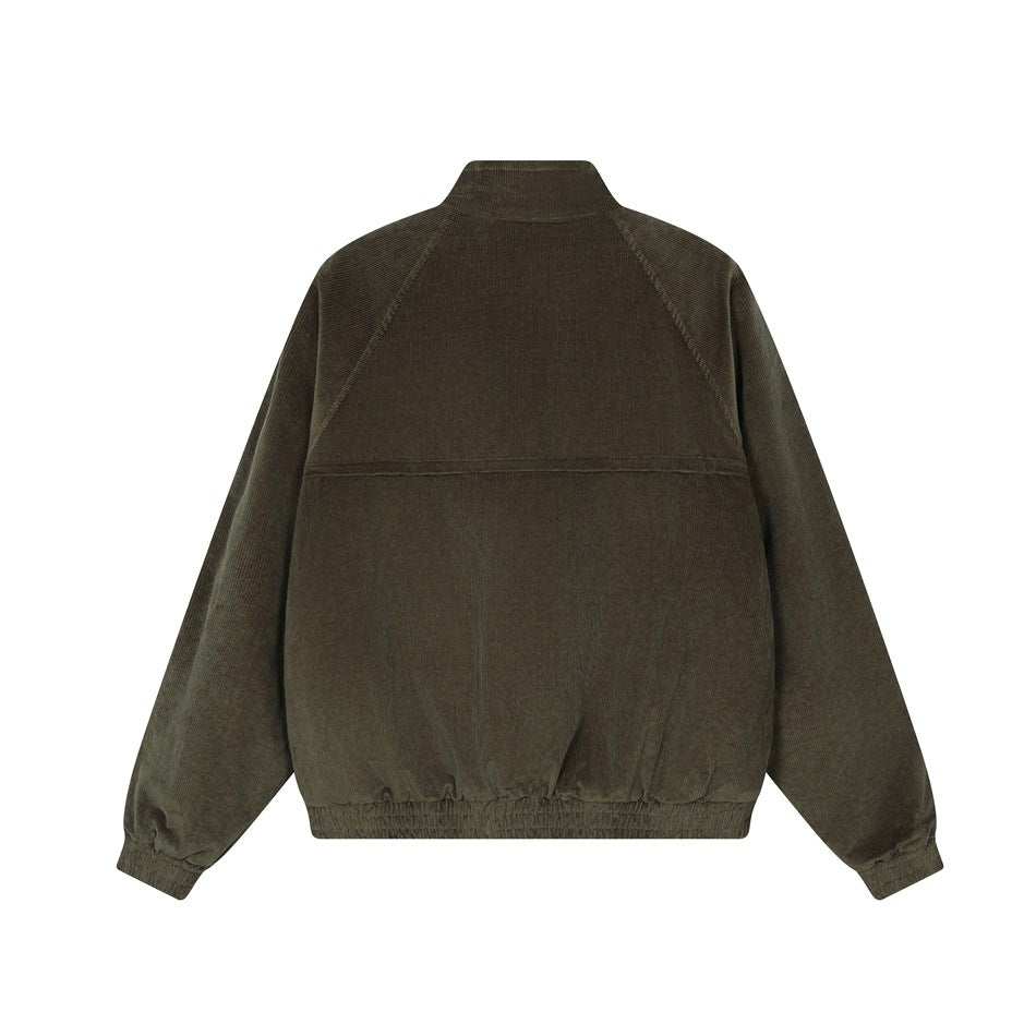Back of a dark olive jacket with a stand collar, raglan sleeves, horizontal yoke seam, and gathered cuffs and hem.