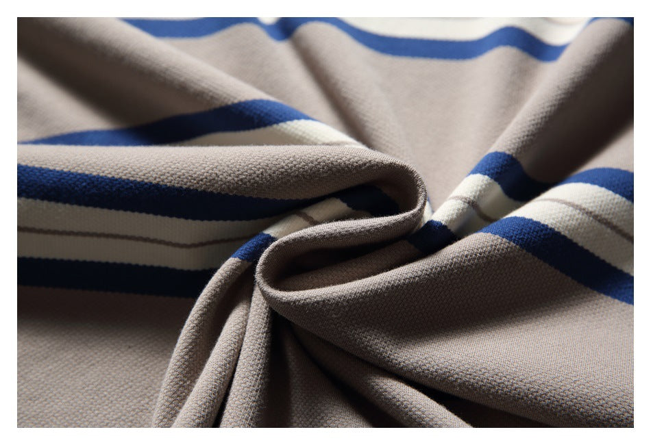 Close-up of folded beige-gray fabric with blue and white stripes, showing its textured surface.