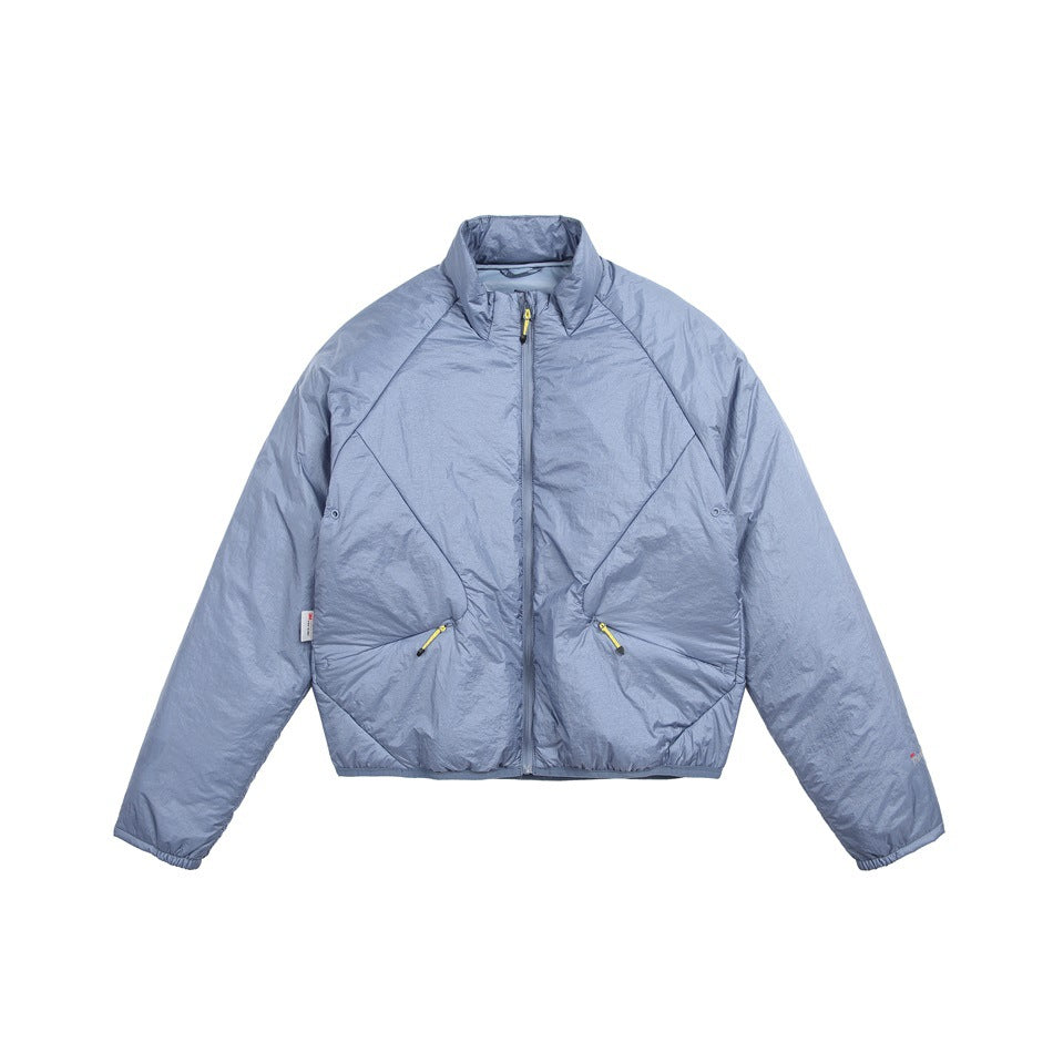 Blue padded stand-collar jacket, front view, with center zipper, diagonal seams and zip pockets with yellow pulls