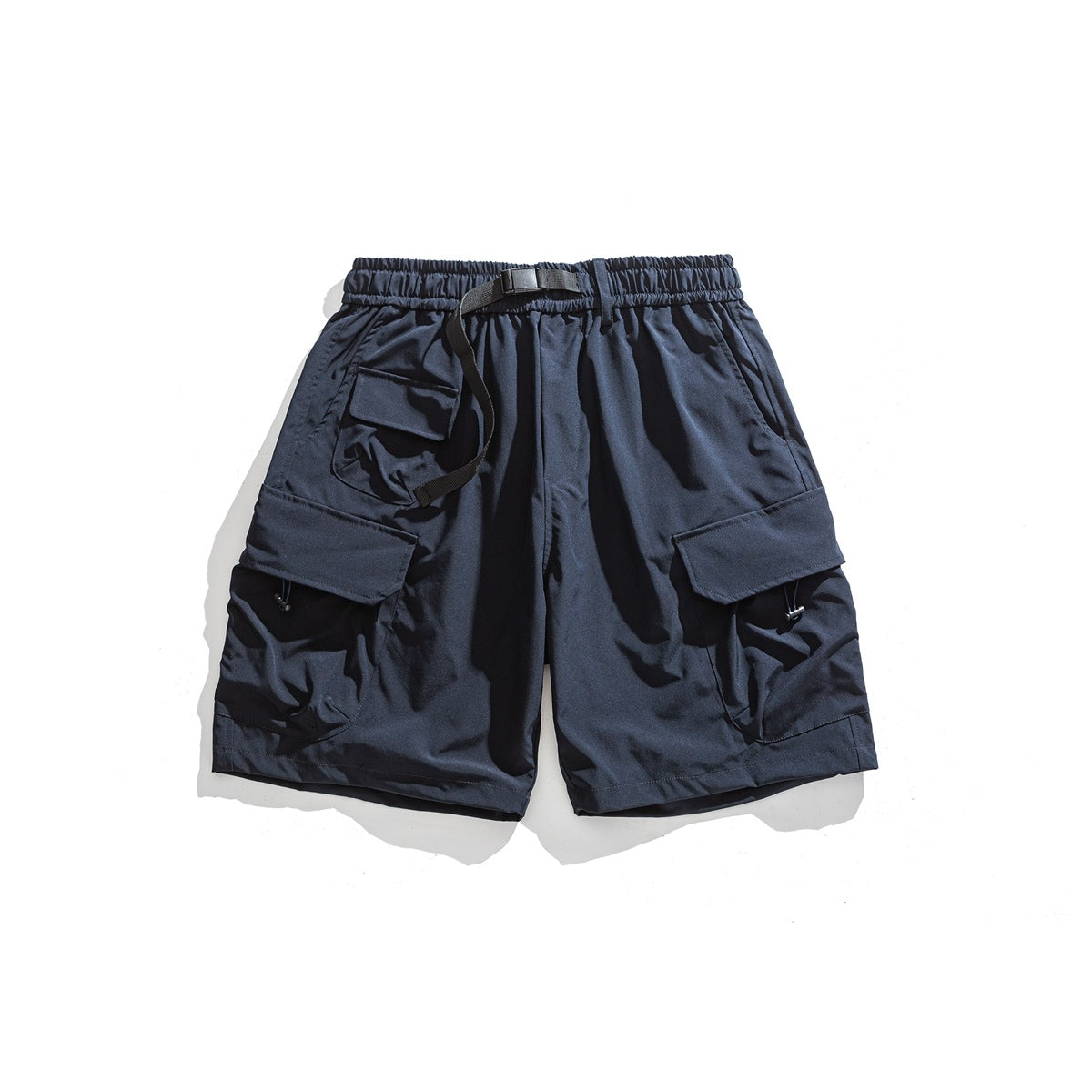 Navy cargo shorts flat lay with elastic waist, black belt buckle and large flap pockets