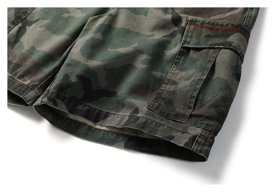 Close-up of the hem and large side pocket on green, brown, and black camouflage trousers.