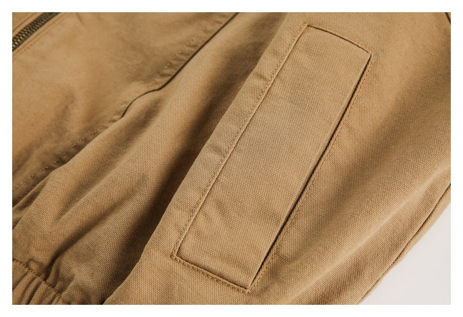 Close-up of a rectangular welt pocket on the tan jacket.