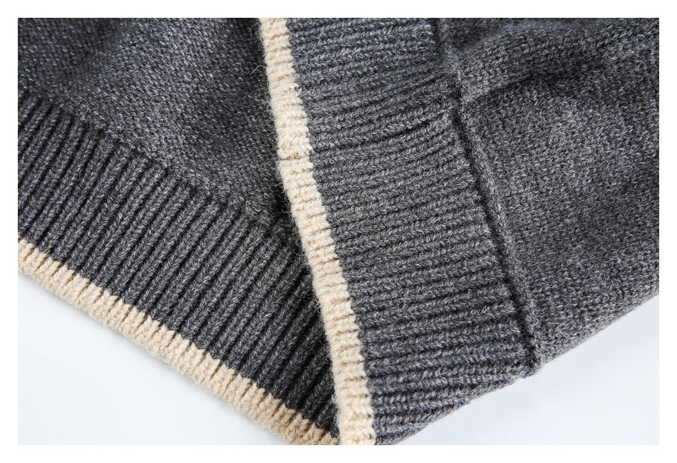 Close-up of overlapping gray ribbed knit edges with cream trim.