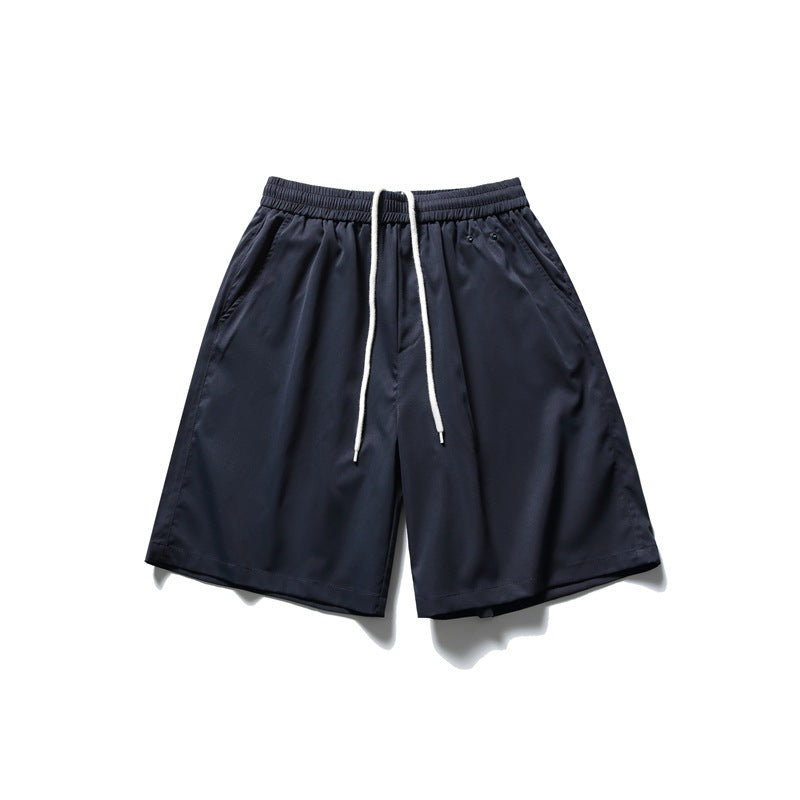Navy knee-length shorts with white drawstring, elastic waistband and side pockets, flat lay front view