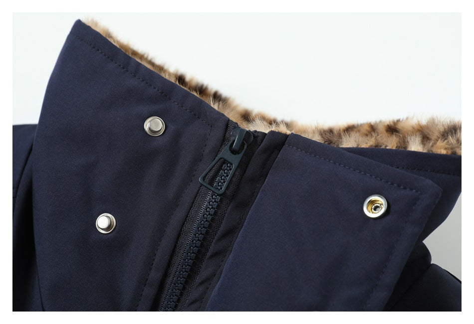 Close-up of a dark navy garment collar with faux-fur lining, zipper and metal snaps.