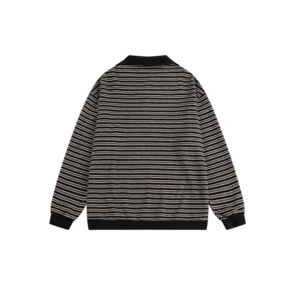 Back of a black long-sleeve pullover with narrow cream and brown stripes and solid black collar, cuffs, and hem.