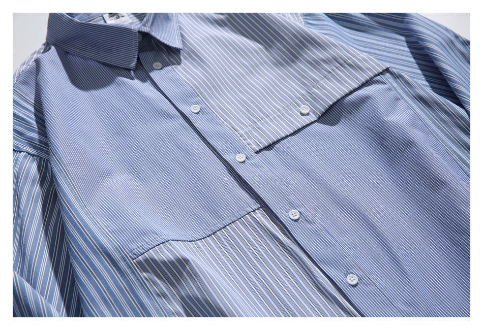 Close-up of the shirt front showing its chest pocket, button placket, and mixed-direction blue-and-white stripes.