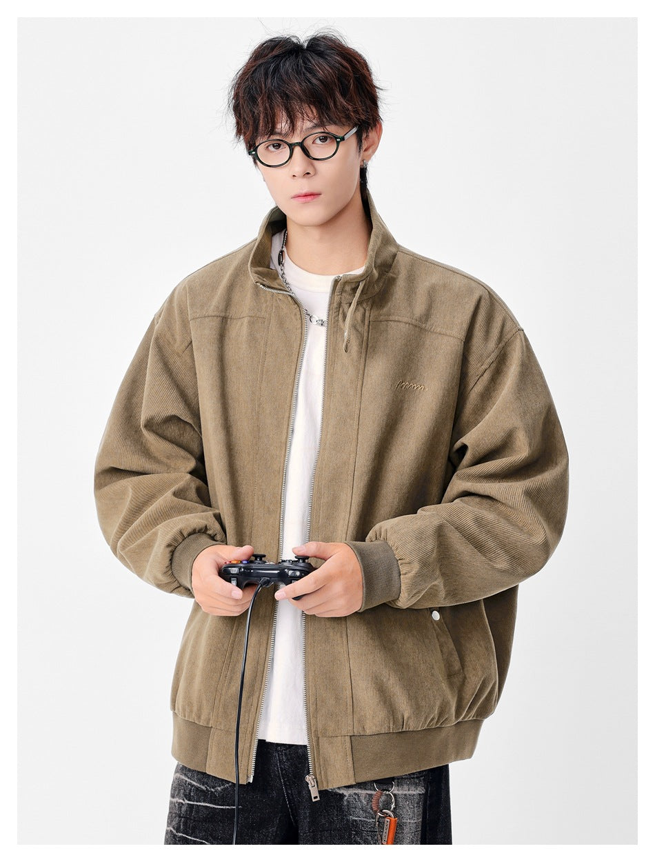 Model wearing a taupe zip-front jacket with a stand collar, oversized sleeves, and ribbed cuffs and hem.