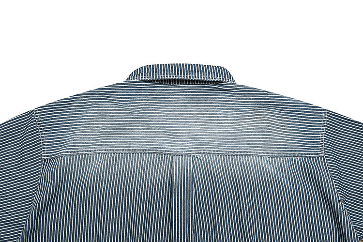 Close-up of the back yoke and collar of a dark shirt with thin white stripes.