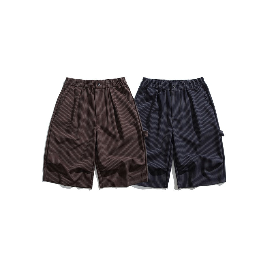 Two pairs of pleated pinstripe shorts shown from the front in brown and navy, with elasticated waistbands.