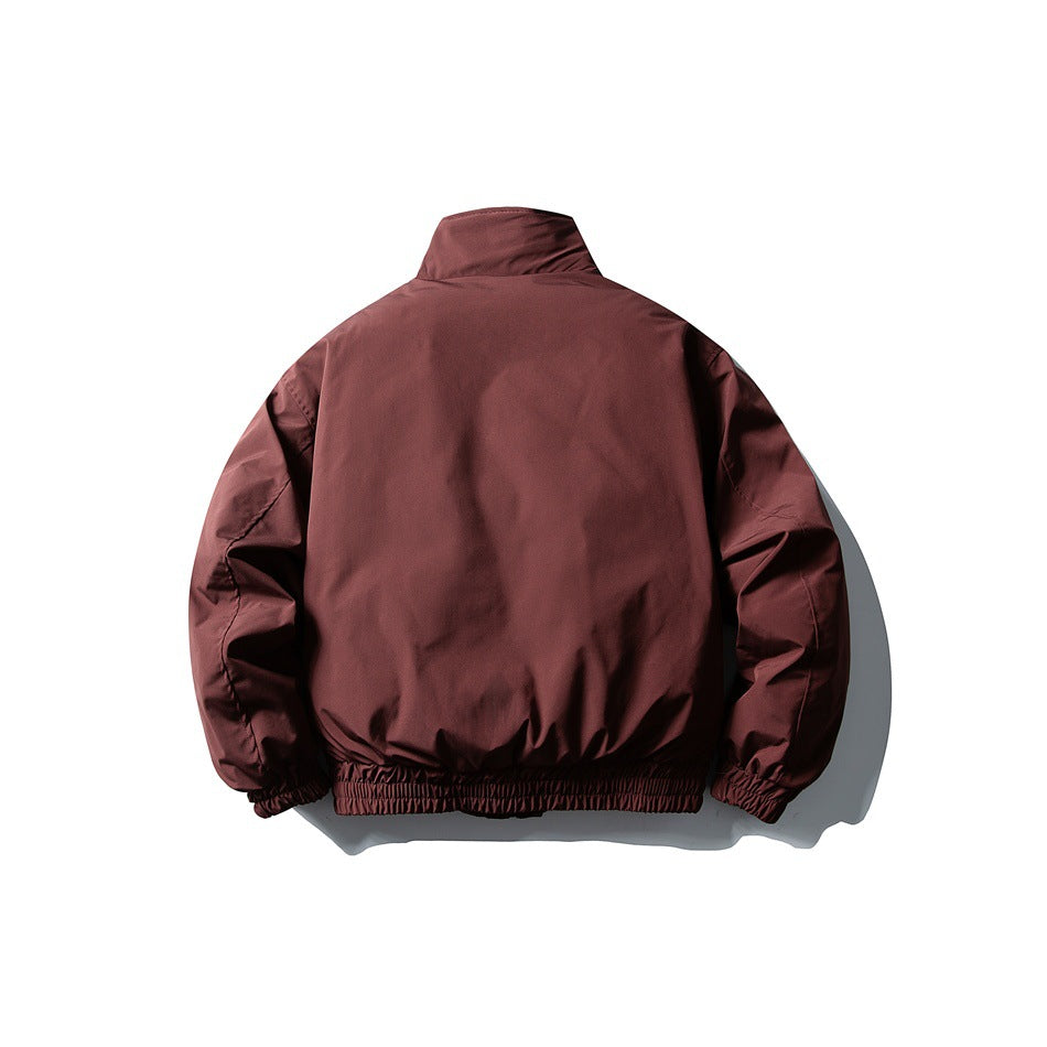 Back view of a plain burgundy jacket with a high collar and gathered elastic cuffs and hem.