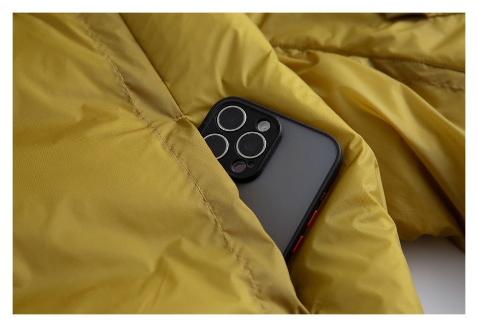 A smartphone is tucked into a pocket of the mustard-yellow jacket, showing the pocket opening.
