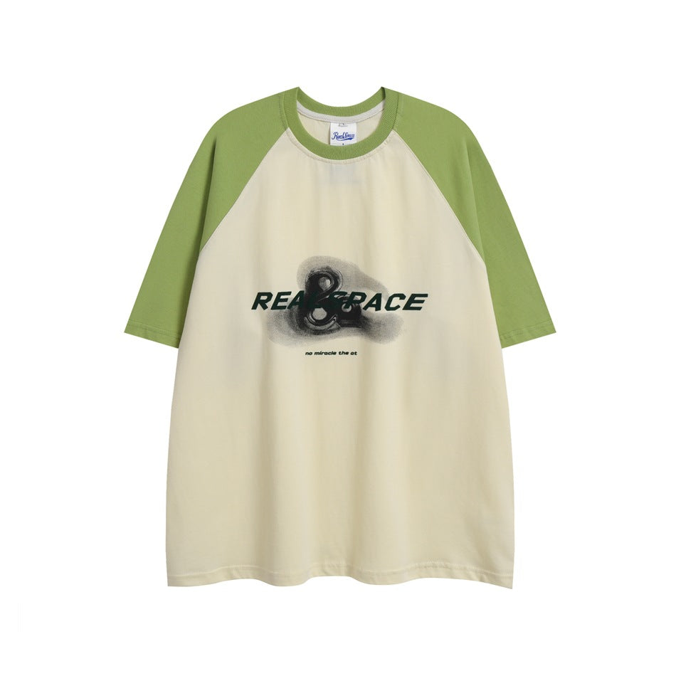 Green and cream raglan short-sleeve T-shirt with dark green chest graphic print, flat lay