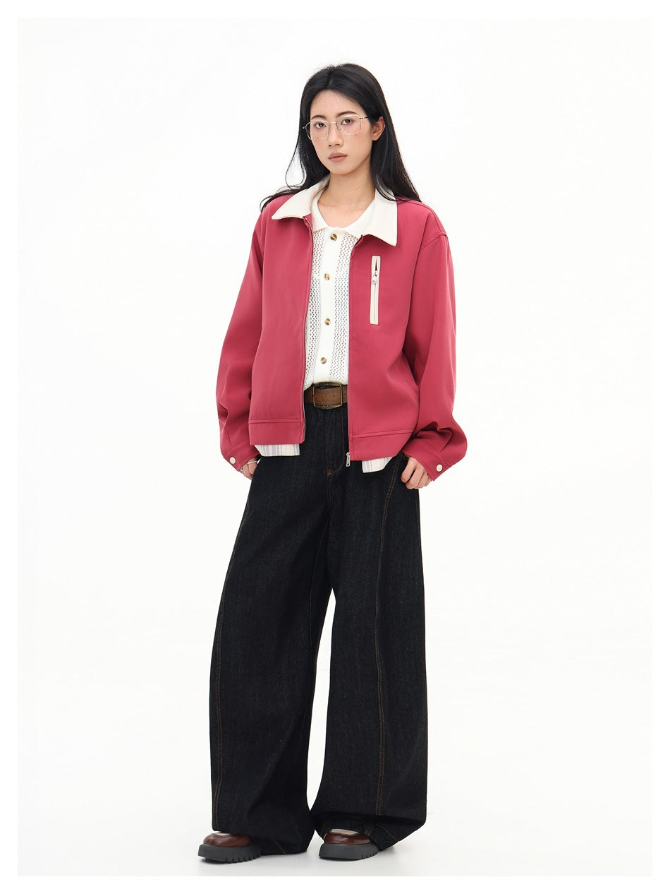 Full-length model wearing an open rose-pink jacket with a cream collar and wide-leg black jeans.