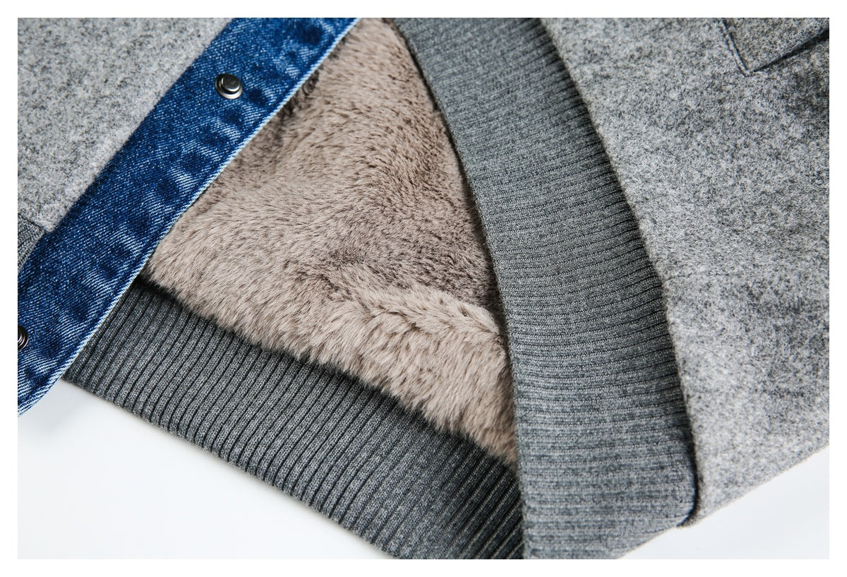 Close-up of a gray jacket showing beige plush lining, ribbed trim, and a blue denim edge with metal snaps.