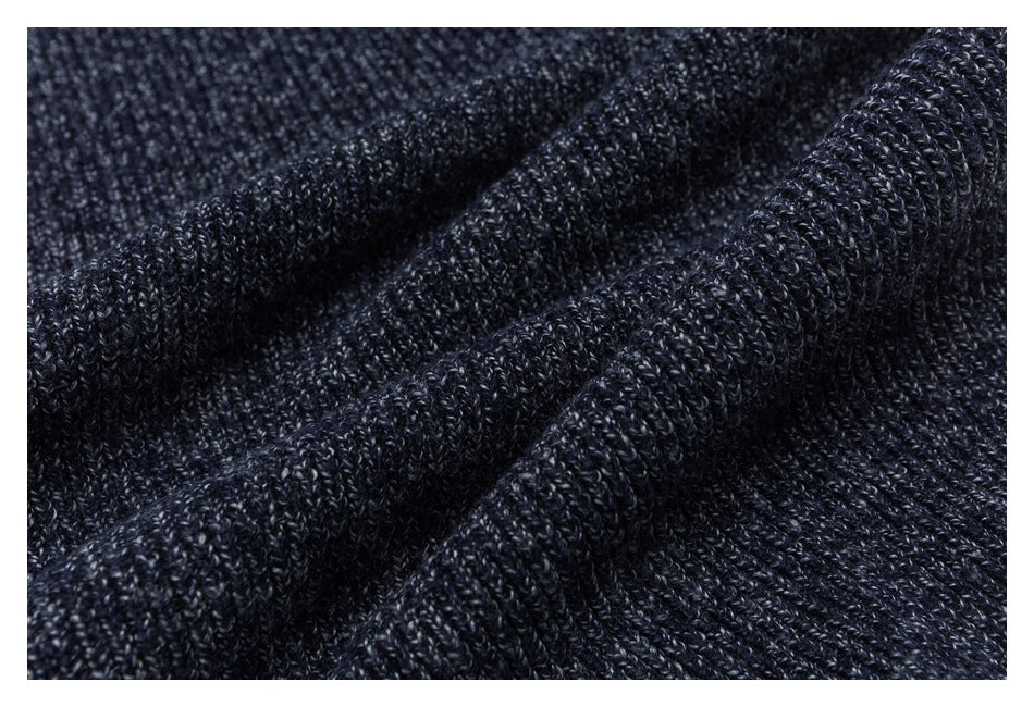 Close-up of dark navy marled knit fabric draped in soft folds.