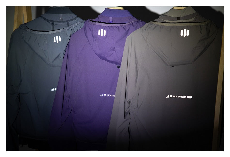 Rear view of three hooded jackets in charcoal, purple and taupe, displayed side by side.