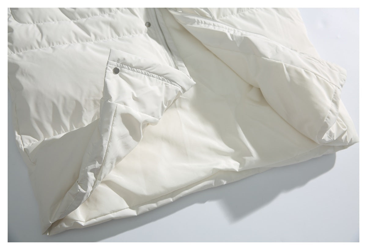 Close-up of the white jacket's snap-button pocket flap, quilted panel, and inner front.