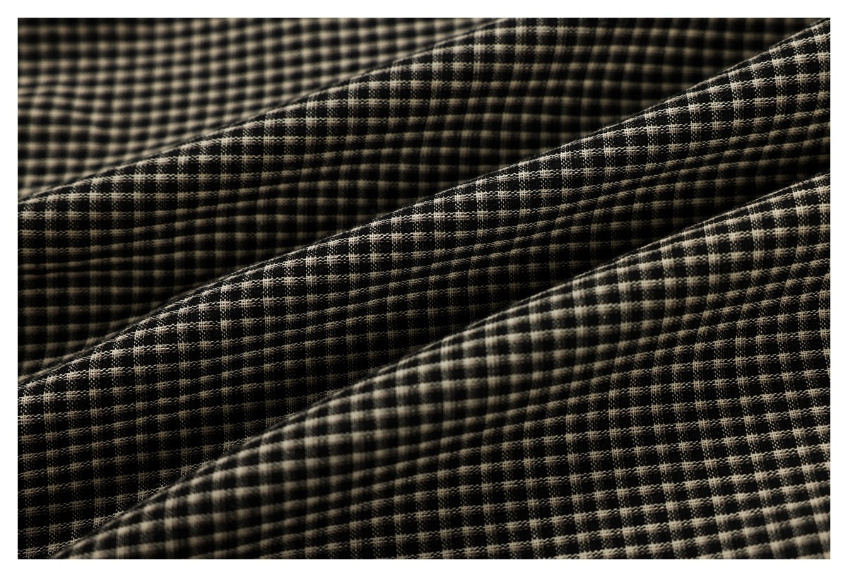 Close-up showing the black-and-beige small-check pattern and texture of the fabric.
