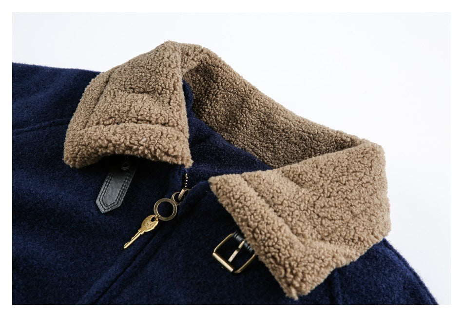 Close-up of a navy jacket with a wide tan curly-fleece collar, buckle detail, and brass zipper pull.